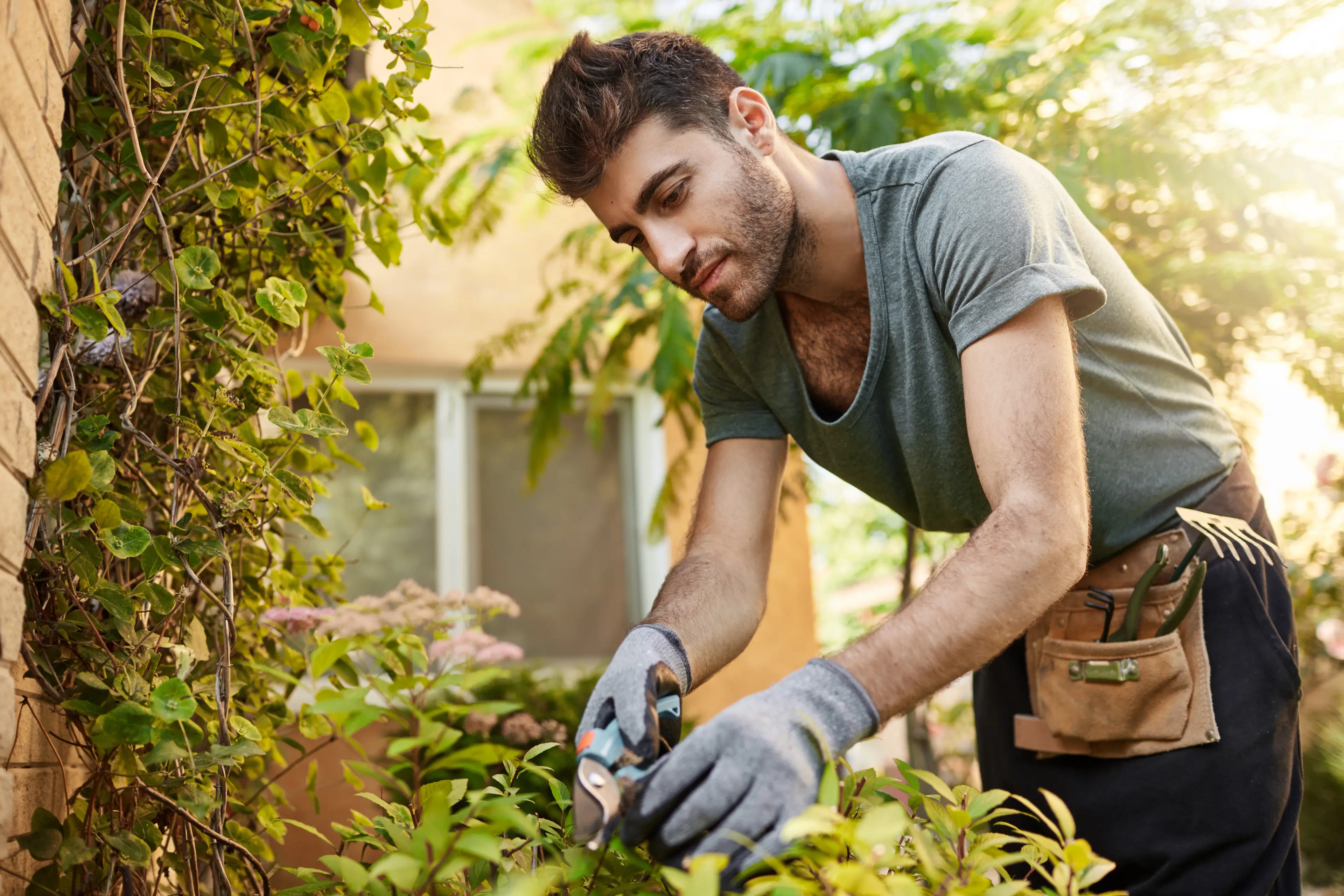 Professional gardener working on landscaping with plants and tools, representing automated home service booking